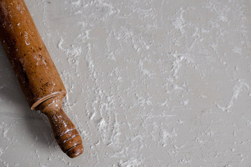 Vintage Wooden Rolling Pin on a Flour Covered Table