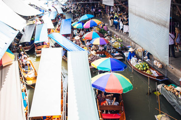 Vibrant Floating Market Scene with Colorful Umbrellas and Boats

