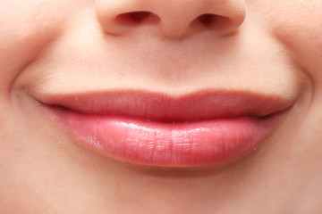 Smiling lips and nose of a young person