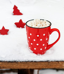  red cup with white polka dots with hot chocolate and marshmallows