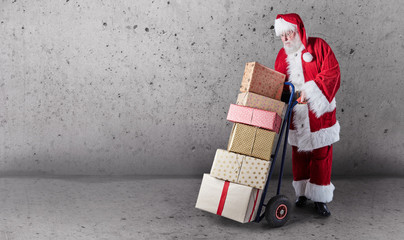 Fototapeta na wymiar Santa with gifts, delivery trolley and copy space