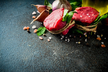 Raw beef fillet steaks mignon with spices and herbs 
