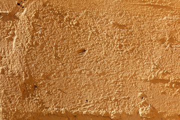 Old wall painted with yellow paint as a background