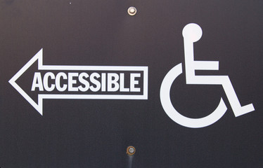 Handicapped Accessible Sign. Black sign with white writing and arrow pointing handicapped...