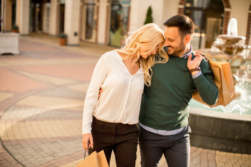 Portrait of happy loving couple with shopping bags