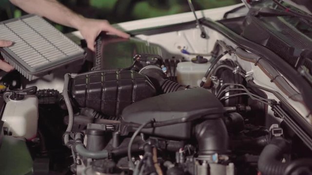 car mechanic checking the engine oil and air filter inspection in a garage or repair shop conducts inspection.4k,30fps.
