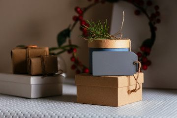 stacked Gifts boxs, wrapped in recycled paper and empty tag on white table