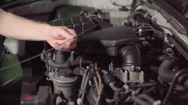 car mechanic checking the engine oil and air filter inspection in a garage or repair shop conducts inspection.4k,30fps.