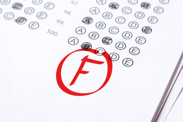 Bad grade F is written with red pen on the tests
