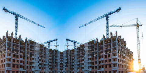 Construction of a new house on the background of the urban landscape . The concept of urban construction .