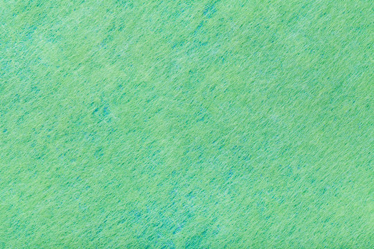 green background of felt fabric. Texture of woolen textile