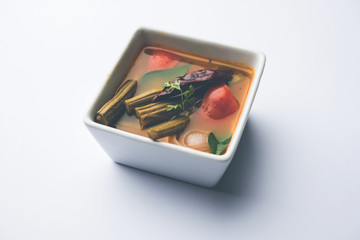 Drumstick Curry or Shevga sheng bhaji or south indian Sambar, served in a bowl over moody background. Selective focus