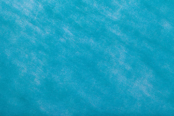 Light blue background of felt fabric. Texture of woolen textile