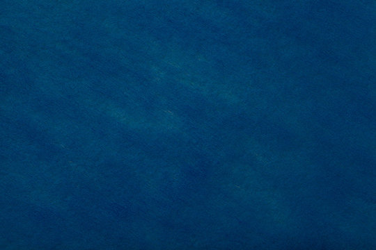 Navy blue background of felt fabric. Texture of woolen textile