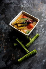 Drumstick Curry or Shevga sheng bhaji or south indian Sambar, served in a bowl over moody...