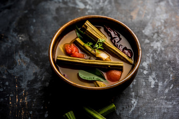Drumstick Curry or Shevga sheng bhaji or south indian Sambar, served in a bowl over moody...