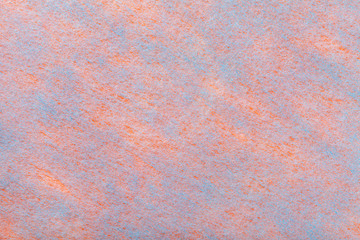 Lght orange and blue background of felt fabric. Texture of woolen textile