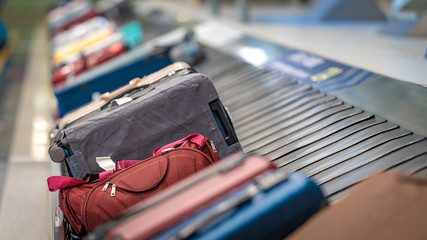 Passengers' Luggage Suitcase Travelling Bags On Conveyor Belt In Airport 