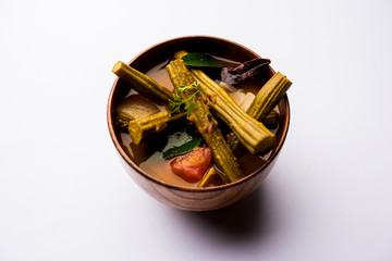Drumstick Curry or Shevga sheng bhaji or south indian Sambar, served in a bowl over moody...