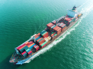 Aerial view container ship full load speed to sea port for logistics import  export or transportation concept background.