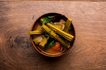 Drumstick Curry or Shevga sheng bhaji or south indian Sambar, served in a bowl over moody...