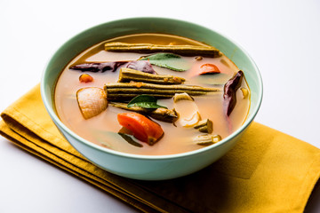 Drumstick Curry or Shevga sheng bhaji or south indian Sambar, served in a bowl over moody background. Selective focus