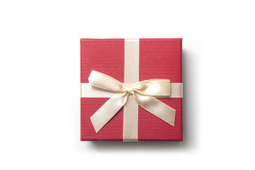 closeup of red square paper box with golden ribbon on white background