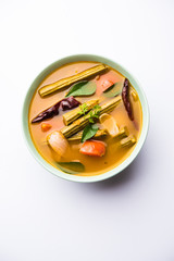 Drumstick Curry or Shevga sheng bhaji or south indian Sambar, served in a bowl over moody background. Selective focus