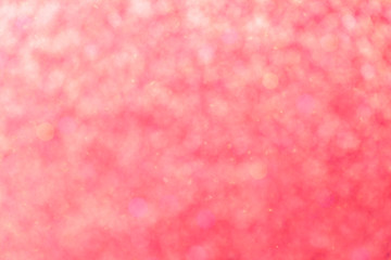 Blurred shiny pink background with sparkling lights.