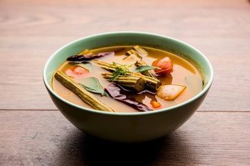 Drumstick Curry or Shevga sheng bhaji or south indian Sambar, served in a bowl over moody...