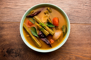 Drumstick Curry or Shevga sheng bhaji or south indian Sambar, served in a bowl over moody background. Selective focus