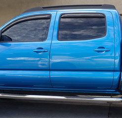 Blue doors on shiny pickup truck. © Noel