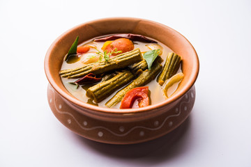 Drumstick Curry or Shevga sheng bhaji or south indian Sambar, served in a bowl over moody background. Selective focus