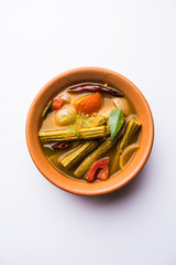 Drumstick Curry or Shevga sheng bhaji or south indian Sambar, served in a bowl over moody background. Selective focus