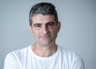 Fototapeta premium Close up portrait of a middle age man in neutral poker facial expressions and human emotions