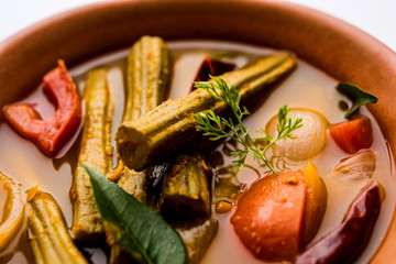 Drumstick Curry or Shevga sheng bhaji or south indian Sambar, served in a bowl over moody background. Selective focus