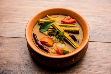 Drumstick Curry or Shevga sheng bhaji or south indian Sambar, served in a bowl over moody...