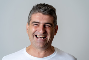 Fototapeta premium Close up portrait of a smiling and laughing mature man in happy face human emotions and expressions