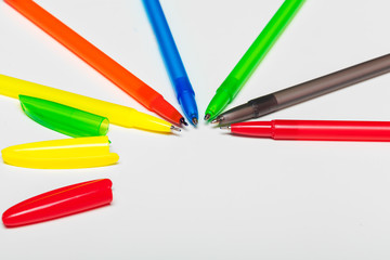 different colors pens isolated on the white background