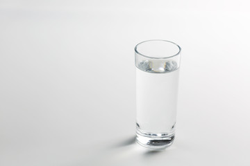 Glass with water on white background.