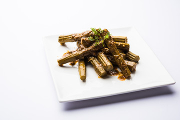 Drumstick masala or Shevga sheng sukhi sabji, served in a plate over moody background. Selective focus