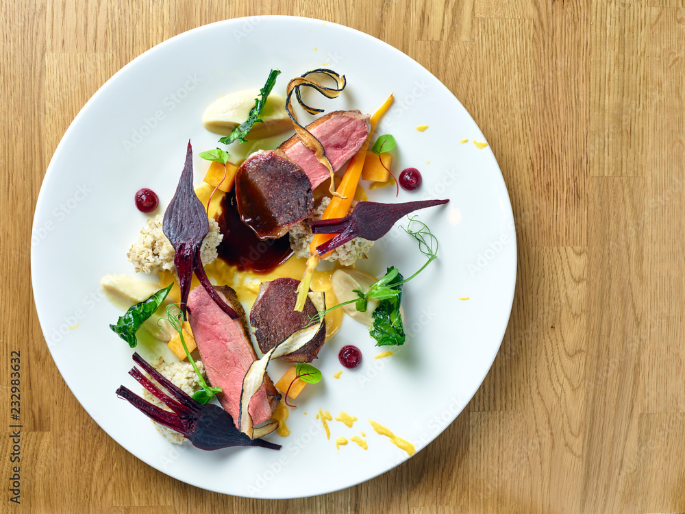 Wall mural duck breast with baby beetroots and dumplings closeup