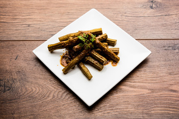 Drumstick masala or Shevga sheng sukhi sabji, served in a plate over moody background. Selective...