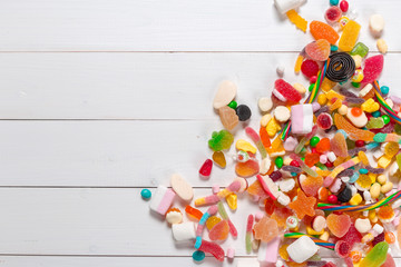 Fototapeta na wymiar Colorful candies on wooden background