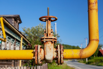 Yellow gas pipe with valve, faucet, in the village