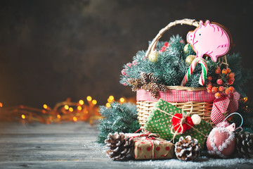 Merry Christmas and happy new year. Basket with Christmas toys and Christmas gifts on a wooden background.