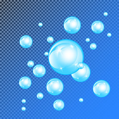 Realistic soap bubbles with rainbow reflection set isolated on the blue transparent background.