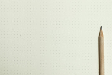White dotted background with a sharp pencil on the right