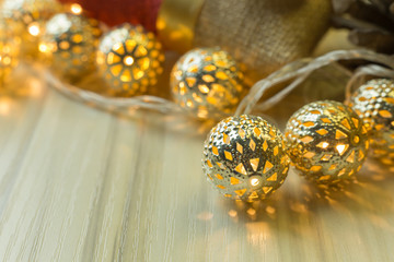 The gold Christmas ball  on  white  wood  table background.