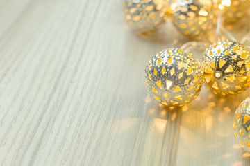 The gold Christmas ball  on  white  wood  table background.